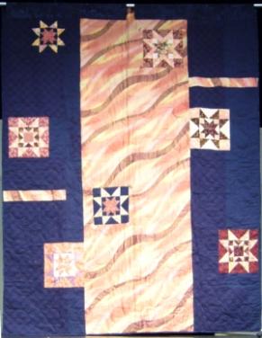 The back of the quilt with star blocks
in navy blues and pinks.