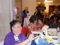 Demonstration of hand quilting and machine piecing